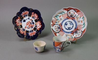 two plates and a cup sitting next to each other