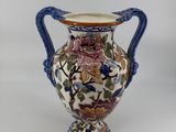 a vase that is sitting on a white surface
