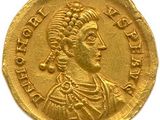une pièce d'or sur laquelle figure l'effigie d'une femme portant une coiffe