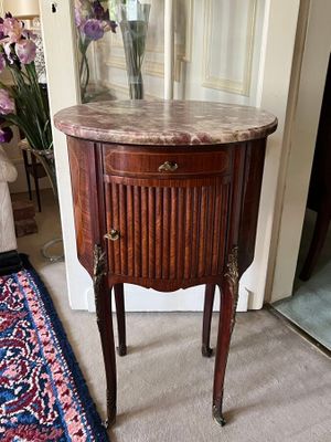 a small table with a marble top in a living room