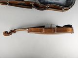 a violin case and a violin on a white surface