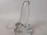 a glass bird that is sitting on top of a table