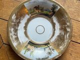 a close up of a bowl sitting on a wooden floor
