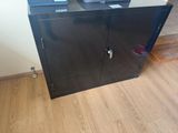 a black metal cabinet with a laptop on top of it