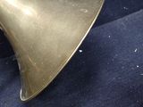 a brass trumpet sitting on a blue cloth