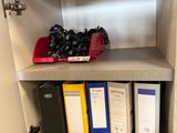 a shelf that has a bunch of binders on it