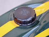 a close up of a green motorcycle with a yellow stripe