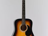 an acoustic guitar hanging on a wall in a room