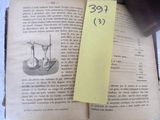 a book with a yellow sticker on it and a bookmark on top of it