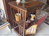 a small wooden table with a vase on top of it