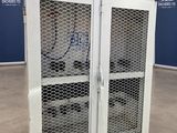 a white cabinet with two doors open in a room