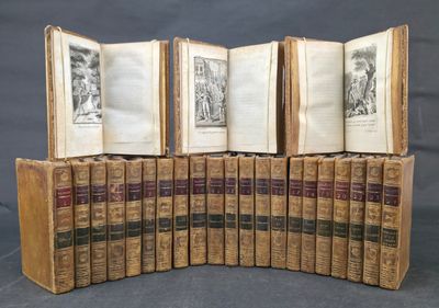 several old books are stacked on top of each other on a table