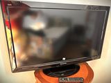 a flat screen tv sitting on top of a wooden stand