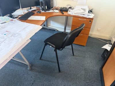 a desk with a chair and a computer on it