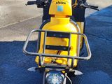 motorcycle parked on the side of the road in a parking lot