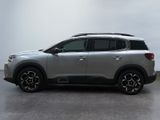 the silver suv is parked in a parking lot on a cloudy day