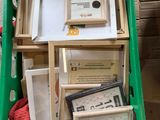 a green box filled with assorted items on the floor