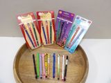a wooden tray holding a variety of pens and pencils