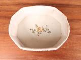 a small white bowl with a floral design on it