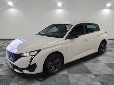 a white car parked in a room with a checkered floor