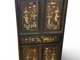 an image of a wooden chest of drawers with asian writing on the doors