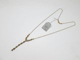 a gold necklace with a chain and a tag on it