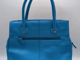 a blue leather handbag on a white background