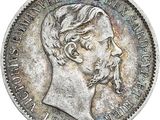 Gros plan sur une pièce de monnaie portant le visage d'un homme
