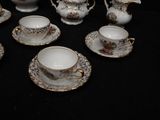 a lot of cups and saucers that are on a table