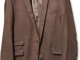 the jacket is brown and has a red tag on it