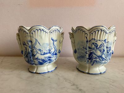 two blue and white vases sitting on top of a marble counter