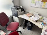 a desk with a chair and a printer on it