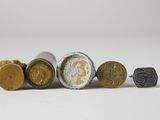 four different types of coins sitting next to each other on a white surface