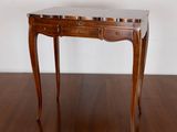 a small wooden table with a marble top on a wooden floor