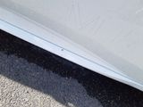 a close up of a car ' s front bumper with scratches on it
