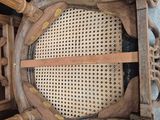 a wooden chair with a wicker back and a wooden seat