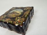 a black box with a picture on it on a white surface