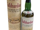 a bottle of tullibardine whisky next to a cardboard box
