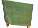 a green chair that is sitting on a white surface