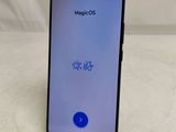 a close up of the back of a smartphone with a blue button on it