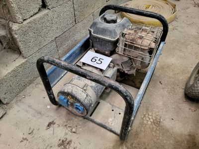 a small engine sitting on the ground next to a fire hydrant