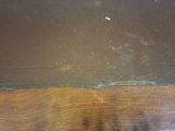 a close up of a wooden table with a piece of paper on it