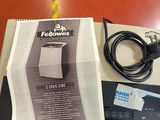a box of food sitting on a table next to a charger and a cord