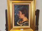 un tableau représentant une femme en robe noire posée sur un chevalet