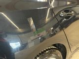 a car with a sticker on the side of it ' s door