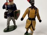 two figurines of men dressed in medieval clothing