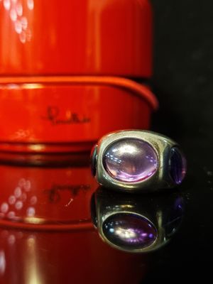 two rings sitting on top of a table next to a red container