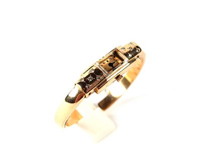 an image of a gold ring with black and white diamonds