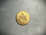a close up of a coin on a table with a black background