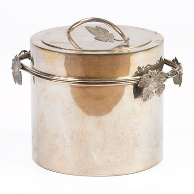 a silver container with a handle and a leaf on it
